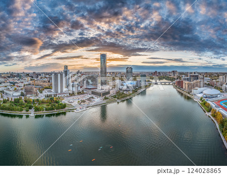 Yekaterinburg city and pond aerial panoramic view at summer or early autumn sunset. Night city in the early autumn or summer. Yekaterinburg city and pond aerial panoramic view at summer or early autumn sunset. Night city in the early autumn or summer. 124028865