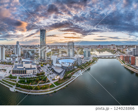 Yekaterinburg city and pond aerial panoramic view at summer or early autumn sunset. Night city in the early autumn or summer. Yekaterinburg city and pond aerial panoramic view at summer or early autumn sunset. Night city in the early autumn or summer. 124028866