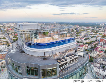 Aerial view of the Yekaterinburg city center with Vysotsky skyscraper. Beautiful landscape of a high-rise building with a rooftop pool and glass facade in Russia Aerial view of the Yekaterinburg city center with Vysotsky skyscraper. Beautiful landscape of a high-rise building with a rooftop pool and glass facade in Russia 124028874