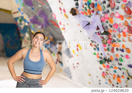 Young woman posing on climbing wall 124029620