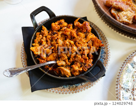 Image of fry pan with fried beef with chorizo on table 124029748