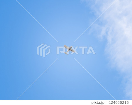 Small ultralight airplane with overhead wing and single propeller flying in sunset sky. 124030216