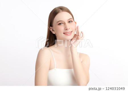 A beautiful young woman with clean, fresh skin against a white background. Skincare, facial treatment, cosmetology, beauty, and spa themes. An elegant portrait of an woman. 124031049