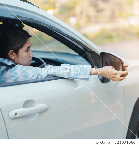 Business woman driver adjusting side view mirror a car. Journey, trip and safety Transportation concepts 124031066