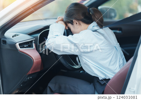 woman feeling stress and angry during drive car long time. Asian girl tired and fatigue having headache after driving car in traffic jam. Sleepy, stretching and drunk concept woman feeling stress and angry during drive car long time. Asian girl tired and fatigue having headache after driving car in traffic jam. Sleepy, stretching and drunk concept 124031081
