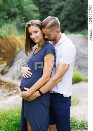 Loving Couple Waiting For Baby Outdoors In Summer 124031769