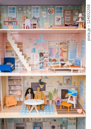 Colorful miniature dollhouse with detailed rooms and figurines, showcasing domestic life in a stylish interior setting Colorful miniature dollhouse with detailed rooms and figurines, showcasing domestic life in a stylish interior setting 124032208