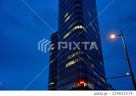 Modern high-rise office building with illuminated windows at night 124032574