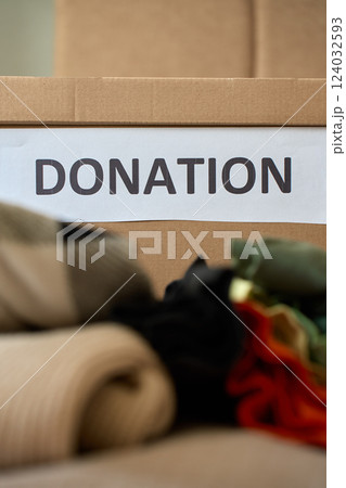 Clothes prepared for donation in cardboard box 124032593
