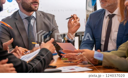 Line of writing hands, Group of business professionals in a productive discussion at a conference meeting Line of writing hands, Group of business professionals in a productive discussion at a conference meeting 124037020