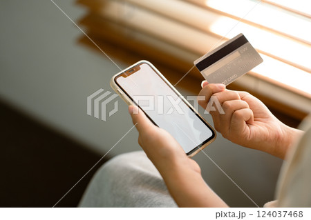 Hand holding smartphone with blank screen and credit card. Digital payments and financial security concept. Hand holding smartphone with blank screen and credit card. Digital payments and financial security concept. 124037468