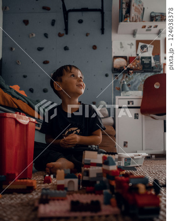 Primary school boy playing with plastic construction 124038378