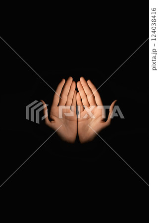 hands in darkness. silhouette over black background 124038416