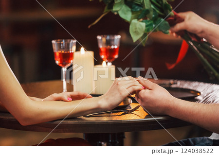 Sitting by the table. Romantic couple have dinner in the restaurant 124038522