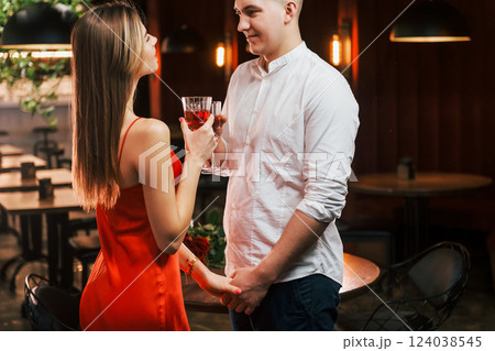 Two people standing together. Romantic couple have dinner in the restaurant Two people standing together. Romantic couple have dinner in the restaurant 124038545