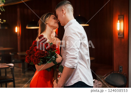 Beautiful roses. Romantic couple have dinner in the restaurant Beautiful roses. Romantic couple have dinner in the restaurant 124038553