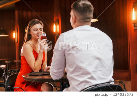 Talking with each other. Romantic couple have dinner in the restaurant 124038572