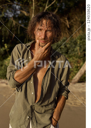 happy boy on the beach at sunset. handsome wet hair man on the sea coast happy boy on the beach at sunset. handsome wet hair man on the sea coast 124038620