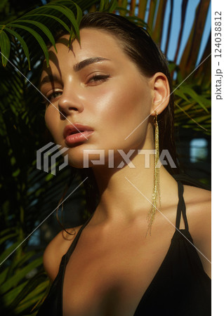 beautiful summer girl. young sexy woman in bikini under palm tree beautiful summer girl. young sexy woman in bikini under palm tree 124038812
