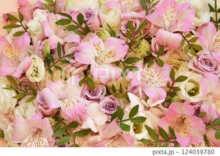 Delicate blooming festive alstroemerias and roses, blossoming pink summer flowers bright background, bouquet floral card, selective focus, shallow focus 124039780