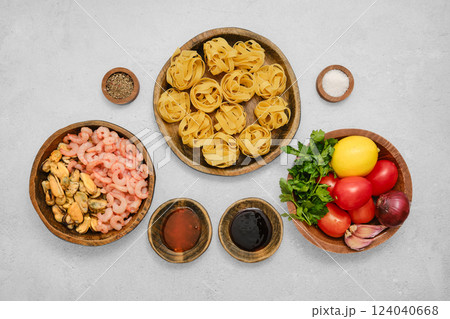 Fresh seafood and pasta ingredients prepared for a delightful cooking experience at home Fresh seafood and pasta ingredients prepared for a delightful cooking experience at home 124040668