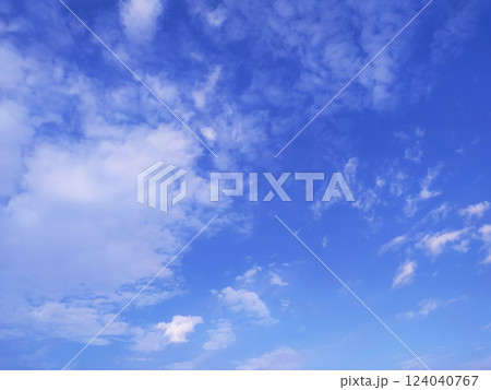 Clear blue sky texture and white fluffy cloud nature background. The sun shines bright in the daytime in summer Clear blue sky texture and white fluffy cloud nature background. The sun shines bright in the daytime in summer 124040767
