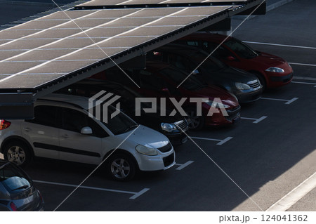 Parking space with solar panels on a roof. Solar canopy 124041362