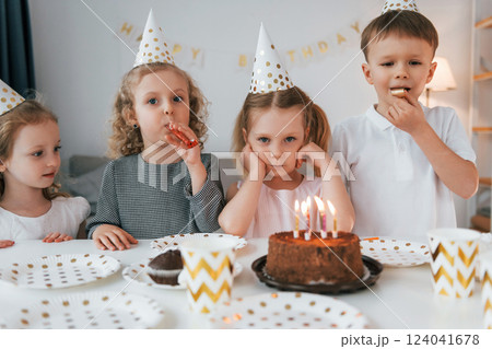 Celebrating brithday. Group of children is together at home at daytime 124041678