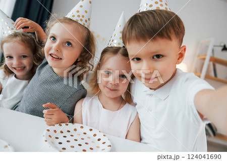 Making selfie. Celebrating brithday. Group of children is together at home at daytime 124041690