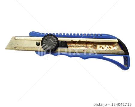 Closeup of a wellused utility knife, showcasing its blue handle and metallic blade with visible rust.  A powerful image representing hard work, craftsmanship, or the passage of time. 124041713