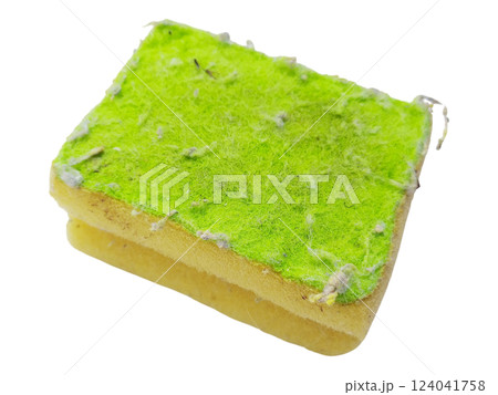 Closeup of a used cleaning sponge, showcasing texture and wear.  The lime green scouring pad layer is heavily soiled with lint and debris, offering a visual metaphor for hard work and completion. 124041758