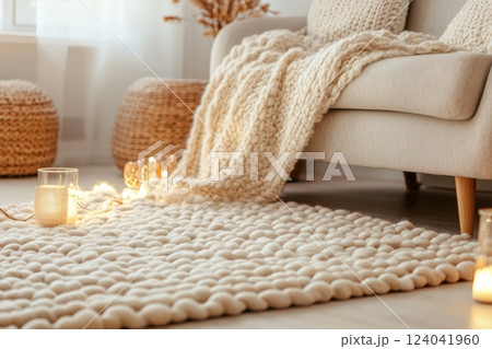 Cozy scandinavian living room with soft woolen rug and knitted pouf 124041960