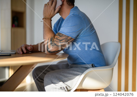 Diabetic man with CGM sensor making phone call. 124042076