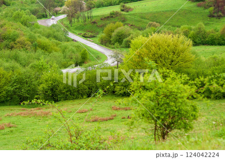 travel landscape, with road through valley. green nature scenery in spring for tourism. beautiful rural background view from the hill with forest. outdoor adventure in the rain travel landscape, with road through valley. green nature scenery in spring for tourism. beautiful rural background view from the hill with forest. outdoor adventure in the rain 124042224