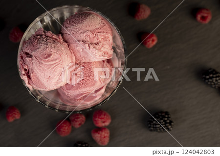 delicious sweet cold raspberry  flavored ice cream and ripe raspberries in a glass 124042803