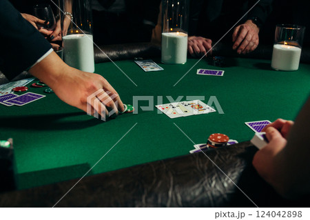 People playing poker on a evening party, entertainment People playing poker on a evening party, entertainment 124042898