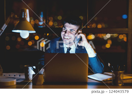 Business Call. Joyful Businessman Having Phone Conversation On Cellphone Sitting Overnight At Workplace In Modern Office. Business Call. Joyful Businessman Having Phone Conversation On Cellphone Sitting Overnight At Workplace In Modern Office. 124043579