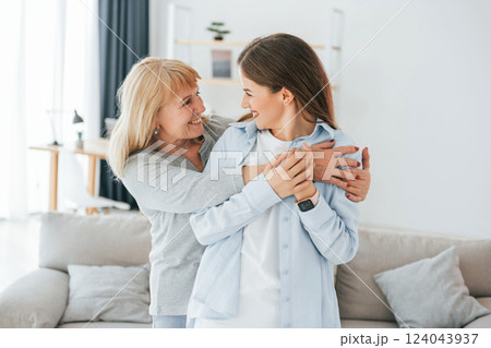 Posing for a camera. Mother and daughter is together at home 124043937