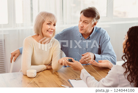 Lung Disease. Female physician giving asthma inhaler to smiling elderly woman, senior couple at doctors office, copyspace Lung Disease. Female physician giving asthma inhaler to smiling elderly woman, senior couple at doctors office, copyspace 124044100