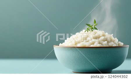 Steaming bowl of creamy risotto with fresh thyme garnish in elegant blue dishware, AI Generative 124044302