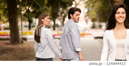 Boyfriend Looking At Other Girl Walking With His Irritated Girlfriend Outdoor In Park. Relationship Problems. Selective Focus 124044415