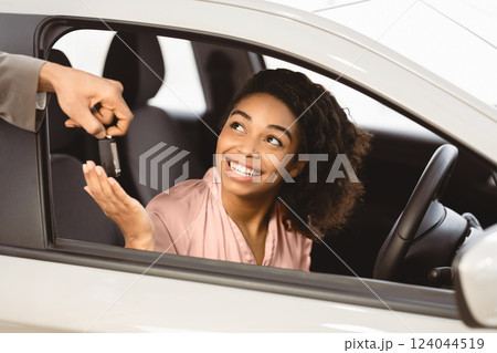 New Car. Auto Dealer Giving African Woman Automobile Key For Test Drive In Dealership Store. Selective Focus 124044519