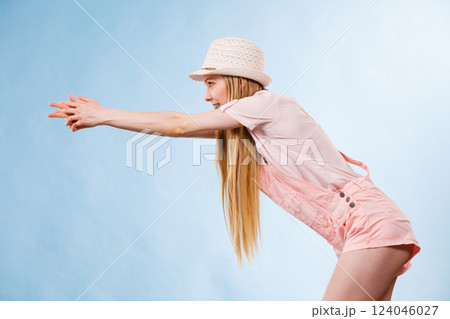 Woman wearing summer outfit pointing 124046027