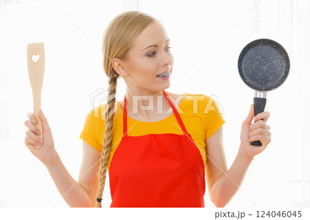 Woman holding cooking pan and spatula 124046045