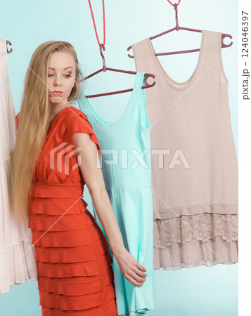 Woman choosing clothes in shop Woman choosing clothes in shop 124046397