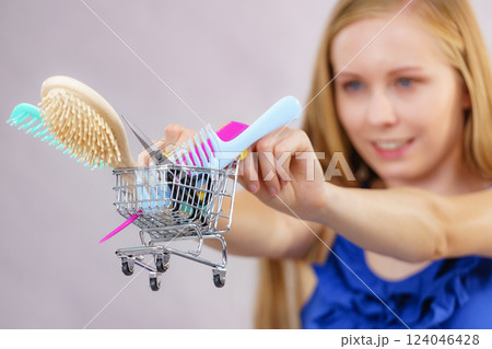 Girl with hair accessories in shopping cart Girl with hair accessories in shopping cart 124046428