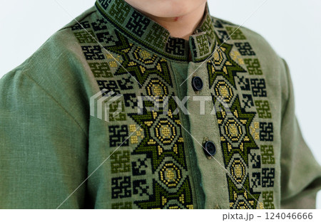 Close-up of Traditional Green Embroidered Shirt Featuring Geometric and Floral Patterns 124046666