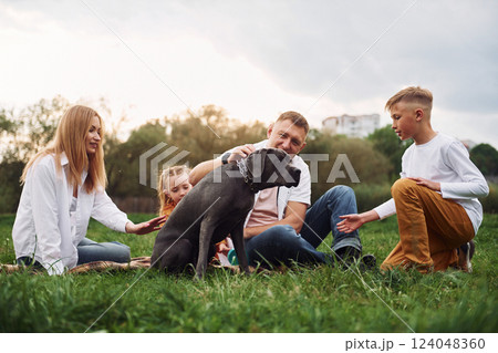 Having fun with dog. Family have weekend outdoors at summertime together 124048360