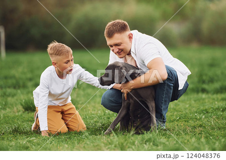 Father with his young son have a walk. With dog Father with his young son have a walk. With dog 124048376