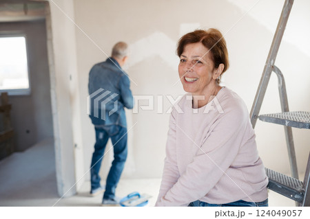 Senior couple renovating their home, a shared retirement activity. Senior couple renovating their home, a shared retirement activity. 124049057